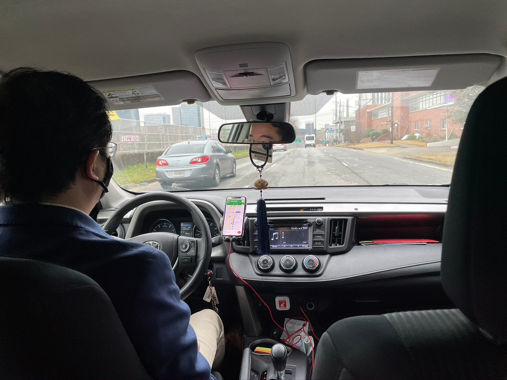 Researcher observing driver during contextual inquiry session in a moving car